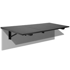 a table that is sitting on top of a white wall and has two black brackets attached to it