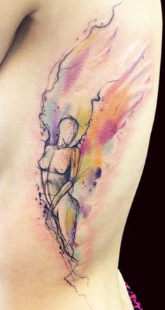 a woman's stomach with a watercolor tattoo on it