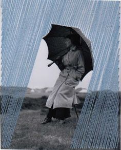 an old photo of a woman holding an umbrella over her head while standing in the rain