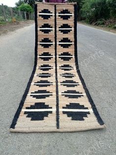 an old rug is laying on the side of the road in front of a person