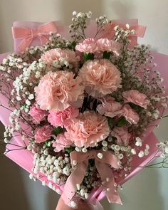 a bouquet of pink carnations and baby's breath