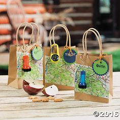 small paper bags with maps and magnets on them