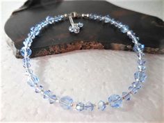 "This Crystal ankle bracelet is the perfect Something Blue for the Bride or for that dazzling finishing touch to any outfit. Get your sparkle on with light blue premium quality crystals that sparkle and shimmer around your ankle, sure to dazzle all who see it. The sterling silver clasp and chain make it adjustable for a comfortable fit and ends in a flirty crystal dangle. The pictured anklet will fit an ankle 9\" to 10\" depending on where you want it to sit (9\" is considered average size for w Elegant Blue Anklets For Gifts, Elegant Blue Anklets For Gift, Adjustable Blue Anklets As Gift, Adjustable Blue Anklets For Party, Blue Anklets With Round Beads For Gift, Blue Round Beads Anklets For Gifts, Blue Beaded Anklets For Party, Something Blue For Bride, Pearl Ankle Bracelet