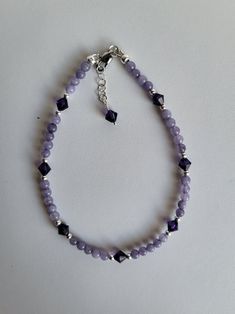 The Chalcedony beads in this anklet are a lavender color, similar to the Lilac flowers. The Czech crystals in the anklet are a little darker than the gemstones. The findings, including a lobster claw clasp, and remaining beads are sterling silver. This anklet has a sterling silver 1" extension with a beaded drop making it adjustable. Custom Orders are always welcome! Ask about free sizing. Chalcedony Crystal, Purple Chalcedony, Silver Anklet, Sterling Silver Anklet, Providence Ri, Lilac Flowers, Silver Anklets, Czech Crystal, Lavender Purple