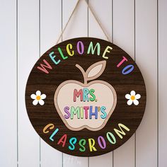 a wooden sign hanging on the wall that says welcome to mrs smith's classroom