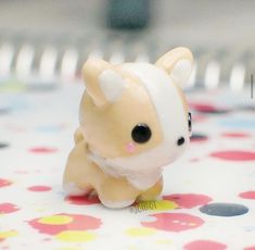 a small toy dog sitting on top of a table