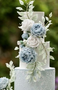 a wedding cake with blue and white flowers on it