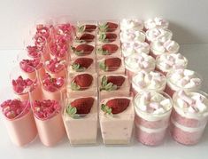 there are many desserts in cups on the table with strawberries and whipped cream