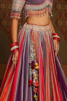 Multi color attached cancan kalidar lehenga with vine striped gota, badla, dori intricate embroidery and heavy tassel ornamentations. Paired with a half sleeves flattering paan neckline padded blouse with gota striped embroidery, dangling glass beads hem detail and checkered gota jaal embellished net scallop border dupatta. - Aza Fashions Multicolor Choli With Latkans For Diwali, Traditional Multicolor Lehenga With Latkans, Multicolor Lehenga With Latkans For Festivals, Fusion Style Red Dupatta For Wedding, Fusion Style Multicolor Choli With Traditional Drape, Multicolor Choli With Latkans For Festivals, Festive Multicolor Lehenga With Latkans, Multicolor Festival Choli With Latkans, Festive Multicolor Choli With Latkans