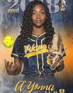 a softball player holding a ball and glove in front of a poster with the number 28 on it