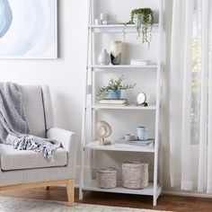 a living room with a chair and a book shelf in it, next to a painting on the wall