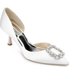 a white shoe with a jewel buckle on the heel