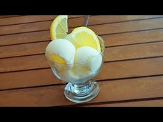 a glass filled with ice and lemon slices