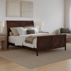 a large bed sitting on top of a hard wood floor next to a white wall