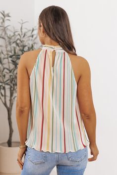 Our Plisse Multi Stripe Pleated Top is crafted with lightweight plisse fabric, featuring vibrant multi-colored stripes that add a pop of color and personality to any outfit! With its relaxed fit and airy feel, it's perfect for warm weather days or layering under a cardigan or jacket when the temperature drops. Pair it with jeans or shorts for a casual and effortless ensemble, or dress it up with tailored trousers or a skirt for a more polished look. Cheap Multicolor Striped Tops, Multicolor Pleated V-neck Dress, Multicolor Stretch V-neck Top, Vibrant Print Multicolor V-neck Top, Multicolor Button-up Top With Striped Collar, Plisse Fabric, Weather Day, Pleat Top, Tailored Trousers