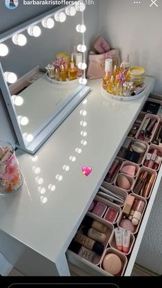 the vanity is full of cosmetics and makeup products, with lights on it's sides