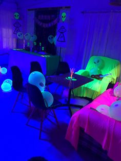 the room is lit up with neon lights and decorations on the tables, chairs, and couches