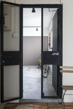 an open door in a room with a bike on the floor and a table next to it