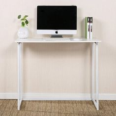 a white desk with a computer on it