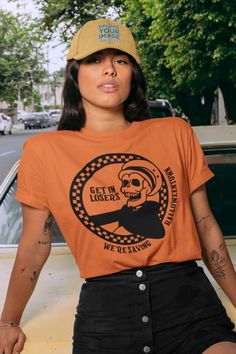 🖤 Product Details:- 100% Soft Ring-Spun Cotton- Light fabric that runs true to size- Unisex- Made in the USA 🇺🇸 🖤 Description:Step into nostalgia and embrace the '90s spooky vibes with our "Get in Losers We're Saving Halloweentown" tee – the ultimate retro tribute to the iconic Skeleton Taxi! Channel your inner Halloween enthusiast as you sport this vintage-inspired gem featuring eerie graphics and eerie appeal. Whether you're cruising through the season or just want to make a spooky stateme 90s Style Tops For Fan Merchandise In Fall, Vintage Crew Neck Halloween Tops, Vintage Crew Neck Tops For Halloween, Retro Fan Merchandise Tops For Fall, Retro Fall Tops For Fan Merchandise, 90s Style Halloween Screen Print Tops, 90s Halloween Screen Print Tops, 90s Style Halloween Tops With Screen Print, 90s Halloween T-shirt With Screen Print