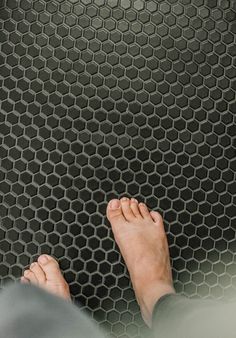 a person standing on top of a metal floor with his feet up in the air