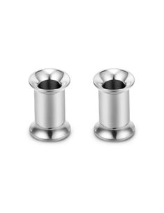 two stainless steel candlesticks sitting on top of each other