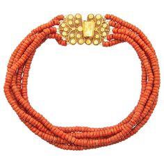 An antique 19th century natural coral necklace created with an impressive large worked 14 karat gold clasp. The clasp is beautifully made of fine filigree and cannetille work, the craftsmanship is stunning. The closure of the clasp is engraved with a floral design. The five strands are set with natural coral barrel-shaped beads and strung with red thread, the thread is not knotted between the beads. The coral is of good quality and has a beautiful color- Corallium Rubrum. In the 16th century, the traditional costume was created in the Netherlands, including jewelry made of coral, which lasted until the 20th century. These types of jewels represent a varied and rich historical Dutch cultural heritage, worn by women in some parts of the Netherlands. This type of necklaces were especially wor Gold Tassel Necklace, String Necklace, Red Coral Necklace, Multi Strand Beaded Necklace, Coral Beads Necklace, Nugget Necklace, Gold Bead Necklace, Vintage Necklaces, Diamond Cross Pendants