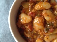 a white bowl filled with pasta and sauce