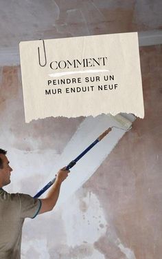 a man holding a paint brush in front of a sign that says how to paint on new plaster with coat paints