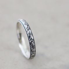 Handmade sterling silver floral band ring.  The pattern is stylized flower and diamond shapes with a mill grain edge.  It is narrow, only 3mm (almost 1/8 inch) wide.  I have given the ring a lightly oxidized (antiqued) patina to enhance the rich detail. Stack it with others or wear it all by itself                                                                         This ring is Made to Order Please allow 5 working days ~before shipping, for me to make your ring in the size you select enter s Small Engagement Rings, Wedding Band Engraving, Mom Ring, Flower Band, Silver Wedding Bands, Sterling Silver Rings Bands, Silver Wedding Rings, Sterling Silver Flowers, Silver Band Ring