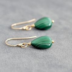 These Malachite drop earrings feature genuine green Malachite teardrops. Each earring showcases a unique Malachite stone, renowned for its stunning green hues and distinctive patterns. These earrings are perfect for those who appreciate natural gemstones and want to incorporate them into their everyday wardrobe. 💎 Also available in sterling silver. 📏Measurements📏 The stones measure 14x10mm. The earrings measure approximately 30 mm in length and 10 mm in width.                💎Matching Neckla Malachite Earrings, Gemstone Drop Earrings, Malachite Jewelry, Basic Jewelry, Green Malachite, Malachite Stone, Green Hues, Green Gemstones, Silver Pieces