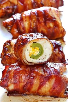 bacon wrapped in sauce and topped with an egg on the top, next to other food items