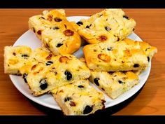 a white plate topped with blueberry scones on top of a wooden table