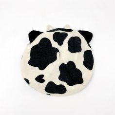 a black and white spotted cow head on a white background