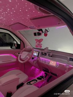 the interior of a car with pink lighting