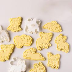 some cut out animals are sitting on a table next to cookie cutters and scissors