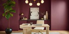 a dining room with purple walls and white chairs in front of a wooden table surrounded by potted plants