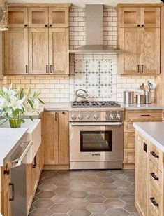 a kitchen with wooden cabinets and stainless steel appliances, including an oven in the center