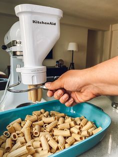 a person is using a food processor to make pasta