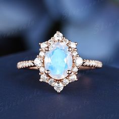 an opal and diamond ring on a table