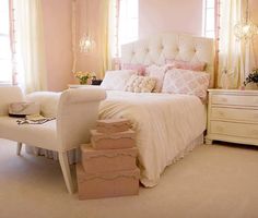 a white bed sitting in a bedroom next to a window