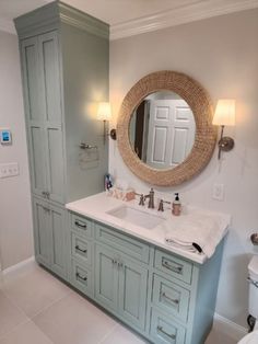 a bathroom with two sinks and a large mirror on the wall above it's cabinetry