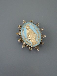 Vintage Jewelry Vintage Brass Blue Brooch Mother Mary Blue Hallmarked Brooches For Anniversary, Collectible Hallmarked Blue Brooches, Antique Blue Jewelry With Brooch, Blue Brooch Lapel Pin As Gift, Blue Oval Brooch For Gifts, Blue Oval Brooch Jewelry, Oval Blue Brooch Jewelry, Oval Blue Brooch, Blue Cabochon Brooches For Wedding