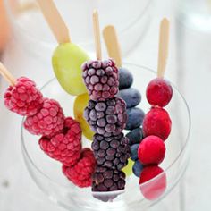 a glass bowl filled with fruit on top of a table