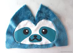 a blue and white hat with a face on it