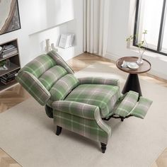 a green and white plaid recliner chair sitting on top of a rug in a living room