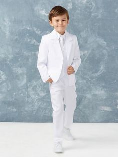 a young boy in a white suit and tie