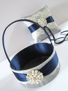 two blue and silver wedding garters sitting on top of a white table next to each other