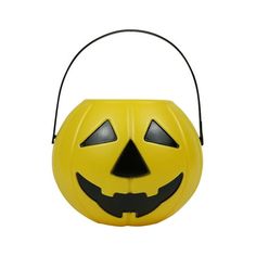 a yellow plastic pumpkin shaped trick bag with black eyes on it's face and mouth