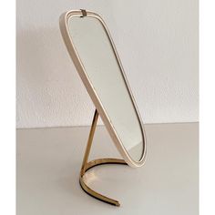 a mirror that is sitting on a stand